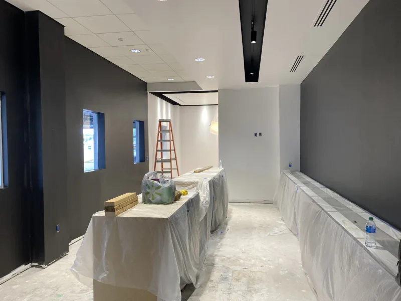 Charcoal accent walls rolled out along a corridor with the counters masked off below